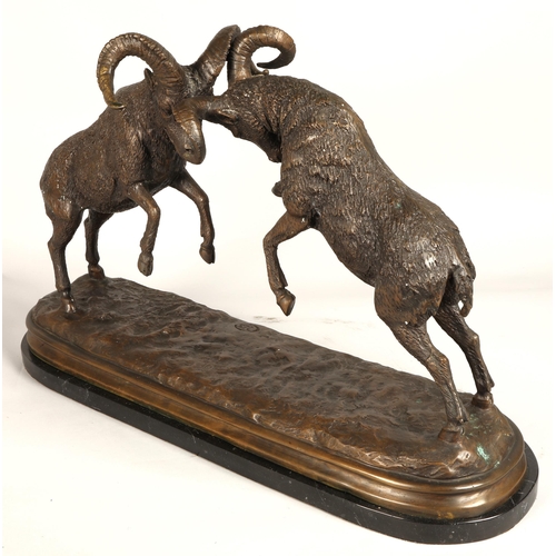 247 - Twentieth century figure of two rams fighting on marble base, signed T R, 75cm long, 47cm high