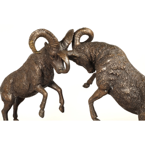 247 - Twentieth century figure of two rams fighting on marble base, signed T R, 75cm long, 47cm high