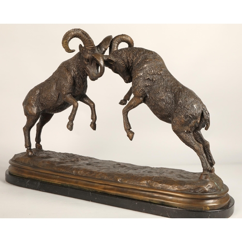 247 - Twentieth century figure of two rams fighting on marble base, signed T R, 75cm long, 47cm high