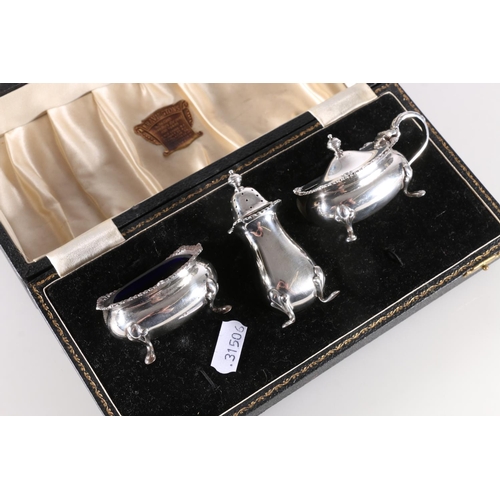 612 - ER.II three piece silver cruet with blue glass liners in fitted case, Adie Bros., Birmingham 1955, s... 