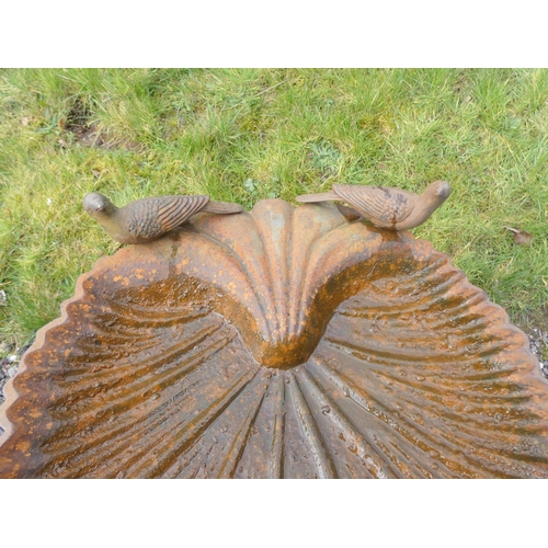 531 - Antique cast iron bird bath decorated with two doves above scallop bowl on a reeded column. 67cms. h... 