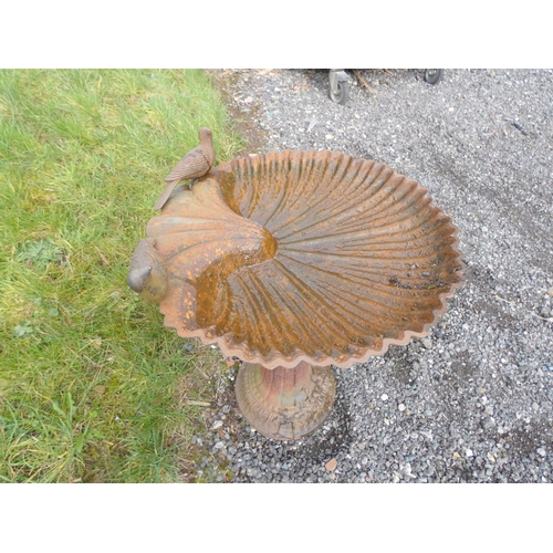 531 - Antique cast iron bird bath decorated with two doves above scallop bowl on a reeded column. 67cms. h... 