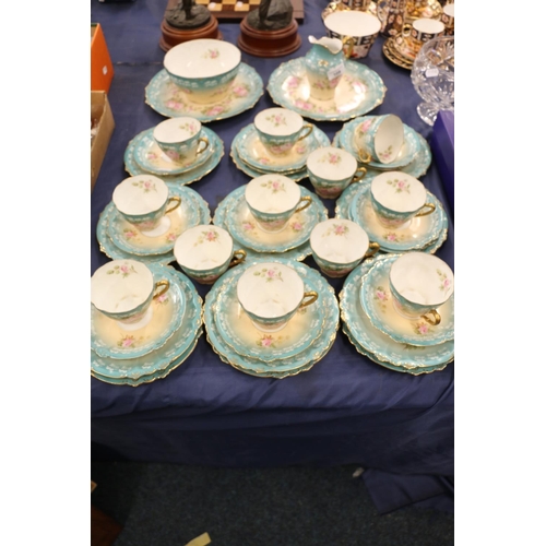 109 - German porcelain part teaset decorated in roses on blue and ivory ground.