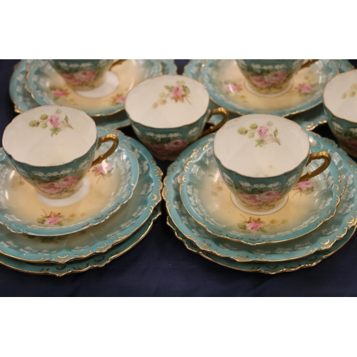 109 - German porcelain part teaset decorated in roses on blue and ivory ground.