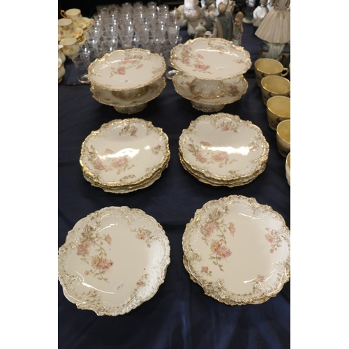 76 - French Limoges style porcelain dessert service comprising ten plates and four comports.