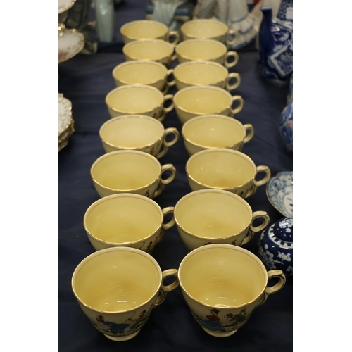 77 - Royal Winton caricature breakfast cups decorated with figures playing golf.