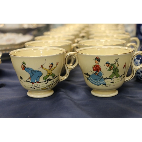 77 - Royal Winton caricature breakfast cups decorated with figures playing golf.