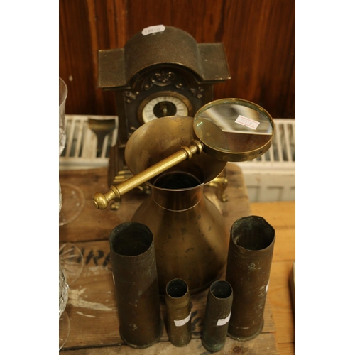 93 - Brassware to include a clock, vase, shell cased and a magnifying glass.