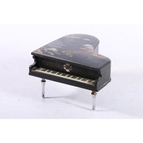 221 - Japanese painted black lacquer musical jewellery casket in the form of a grand piano.