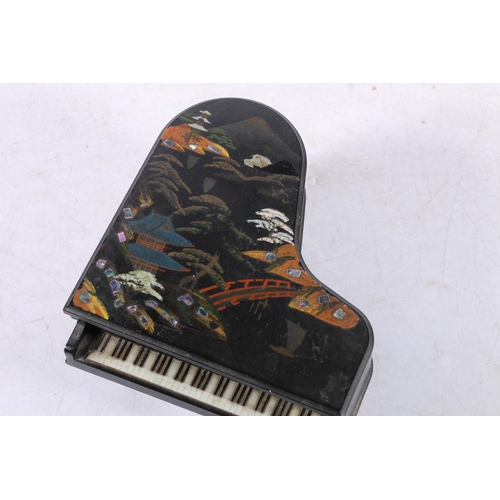 221 - Japanese painted black lacquer musical jewellery casket in the form of a grand piano.