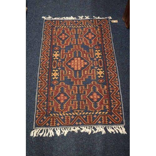 390 - Caucasian rug with geometric designs, 116cm x 74cm.