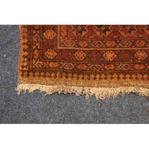 391 - Afghan rust red rug with geometric designs, 190cm x 133cm.