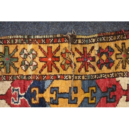 394 - Caucasian geometric design rug with polychrome colouring, 166cm x 141cm.