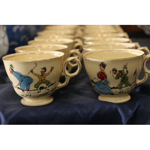 79 - Royal Winton golfing caricature teacups decorated with figures playing golf.