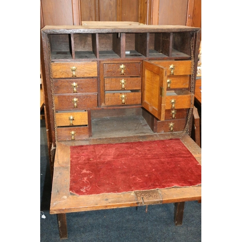 639 - Antique oak campaign cabinet on stand, the fall front with fully fitted interior including drawers, ... 