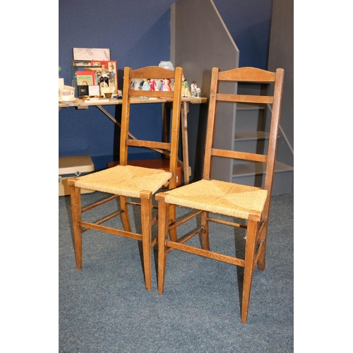 654 - Pair of oak and rush seated hall chairs.