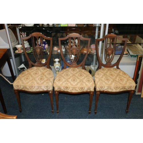 660 - Four Edwardian Sheraton Revival shield back dining chairs.