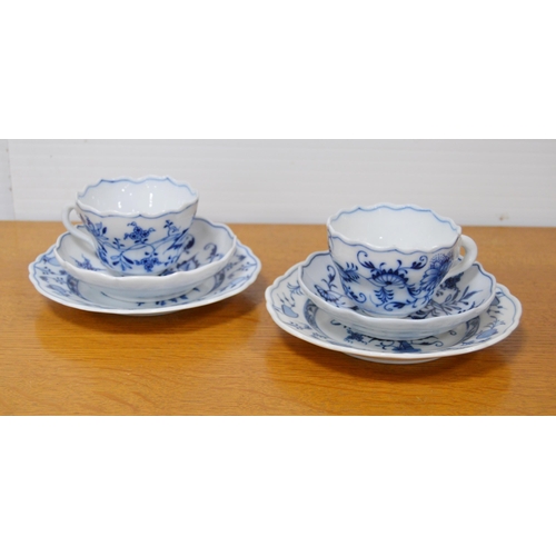 247 - Two Meissen blue and white 'Blue Onion' pattern porcelain trios, comprising a cup, saucer and side p... 