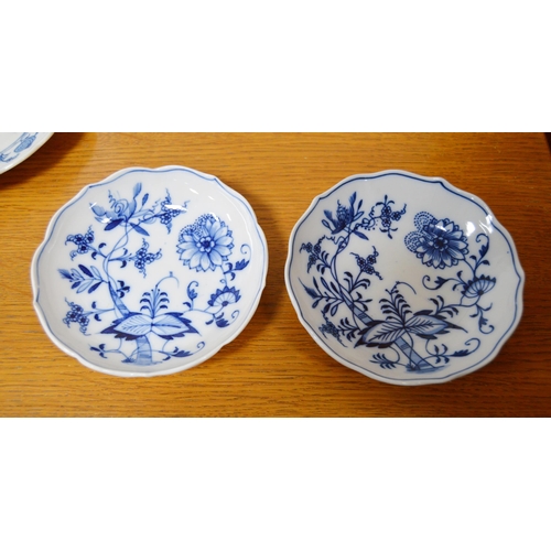 247 - Two Meissen blue and white 'Blue Onion' pattern porcelain trios, comprising a cup, saucer and side p... 