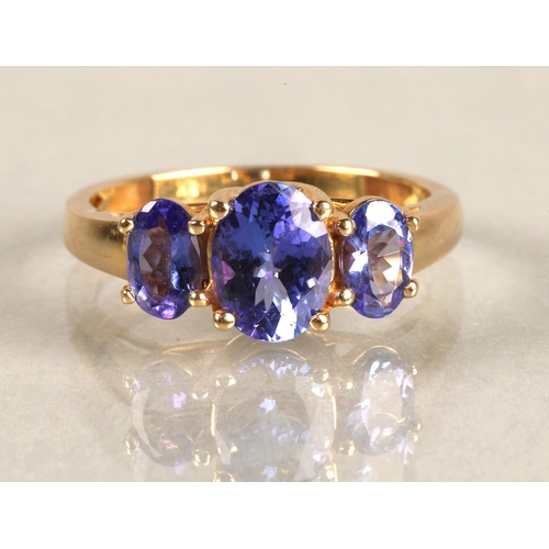 82 - Ladies 18ct yellow gold three stone tanzanite ring,ring size M.