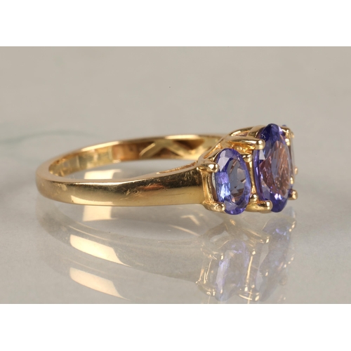 82 - Ladies 18ct yellow gold three stone tanzanite ring,ring size M.