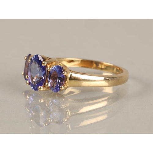 82 - Ladies 18ct yellow gold three stone tanzanite ring,ring size M.