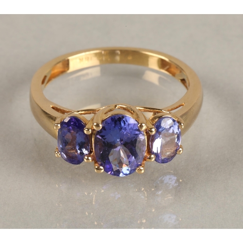 82 - Ladies 18ct yellow gold three stone tanzanite ring,ring size M.