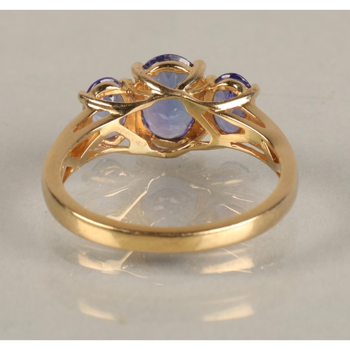 82 - Ladies 18ct yellow gold three stone tanzanite ring,ring size M.