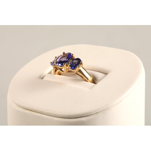 82 - Ladies 18ct yellow gold three stone tanzanite ring,ring size M.