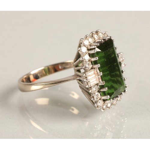 64 - Ladies 18ct white gold emerald and diamond ring, central emerald surrounded by twenty small brillian... 