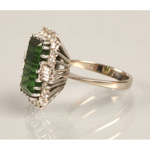 64 - Ladies 18ct white gold emerald and diamond ring, central emerald surrounded by twenty small brillian... 