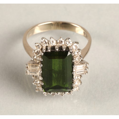 64 - Ladies 18ct white gold emerald and diamond ring, central emerald surrounded by twenty small brillian... 