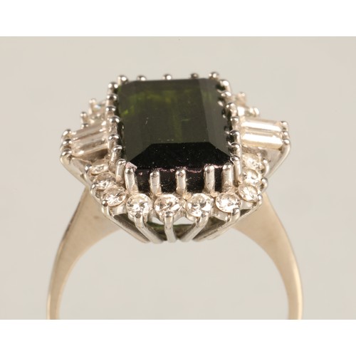 64 - Ladies 18ct white gold emerald and diamond ring, central emerald surrounded by twenty small brillian... 