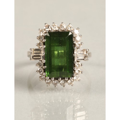 64 - Ladies 18ct white gold emerald and diamond ring, central emerald surrounded by twenty small brillian... 