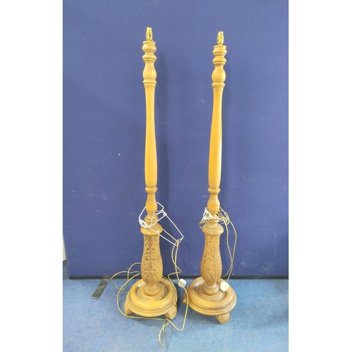 522 - Near pair of reproduction standard lamps in the 18th century style, each on leaf carved turned colum... 