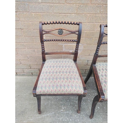 525 - Four antique bobbin turned chairs, three boasting splayed toprails with brass rosettes and drop in s... 