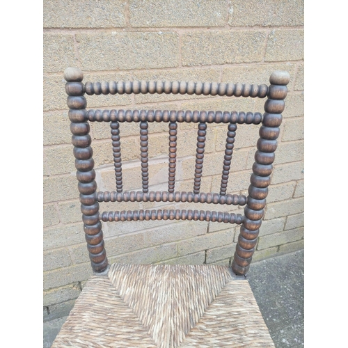 525 - Four antique bobbin turned chairs, three boasting splayed toprails with brass rosettes and drop in s... 