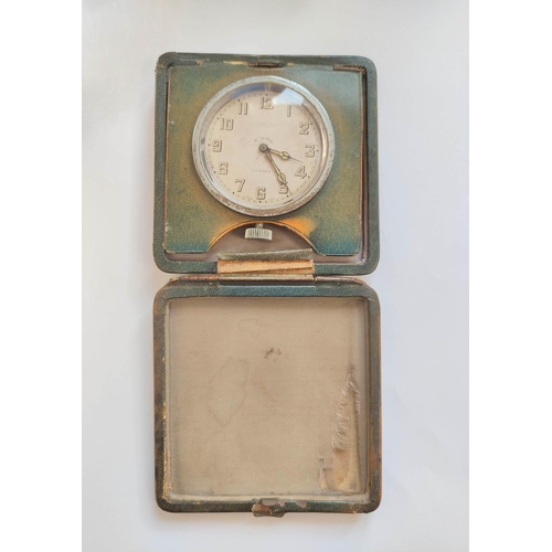 190 - Travelling clock by Benson London, in folding square leather case with gilt monogram 