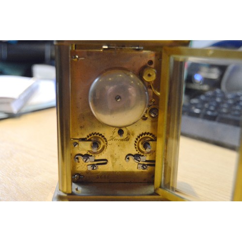 189 - Brass four glass carriage clock with movement viewing window to the top, 12cm high, with tooled case... 