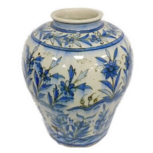 Persian Iznik ovoid pottery vase, probably late 19th century, of large proportions, under glazed with all over blue stylised foliage on a white ground, inscribed 3221 to the underside, 39cm high.