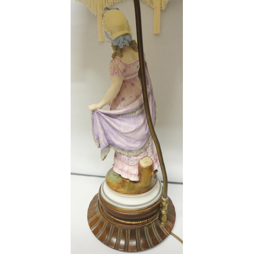 222 - Continental bisque table lamp, c. early 20th century, modelled as a classical maiden in dress, paint... 