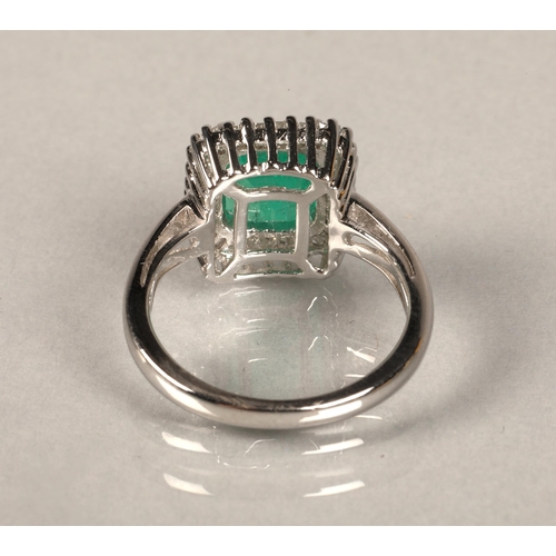 76 - 18ct white gold diamond and emerald ring, Size M