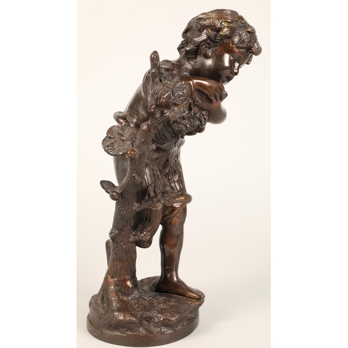 232 - Bronzed figure of a boy leaning on a tree stump on naturalistic base