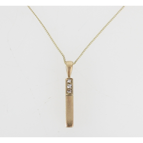 519 - 9ct gold rectangular shape pendant set with three diamonds on a 9ct gold chain, gross 2.7g.