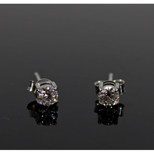 536 - Pair of diamond solitaire stud earrings on 9ct white gold mounts, each diamond approx. 0.28 to 0.3ct... 