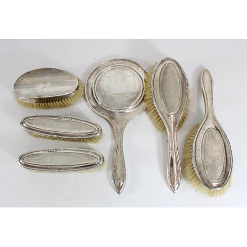 568 - Five-piece hallmarked silver dressing table set with an extra non-matching brush