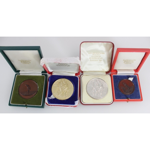 594 - Four golfing medallions in original cases