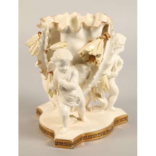 32 - Moore Bros vase, three cupids supporting a bowl,20cm high.