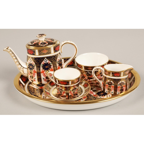 26 - Royal Crown Derby miniature tea service in the imari pattern, comprising of teapot, sugar bowl, crea... 