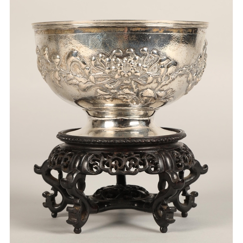 191 - Chinese embossed silver bowl, embossed with flowering prunus, raised on a circular base, maker Hung ... 